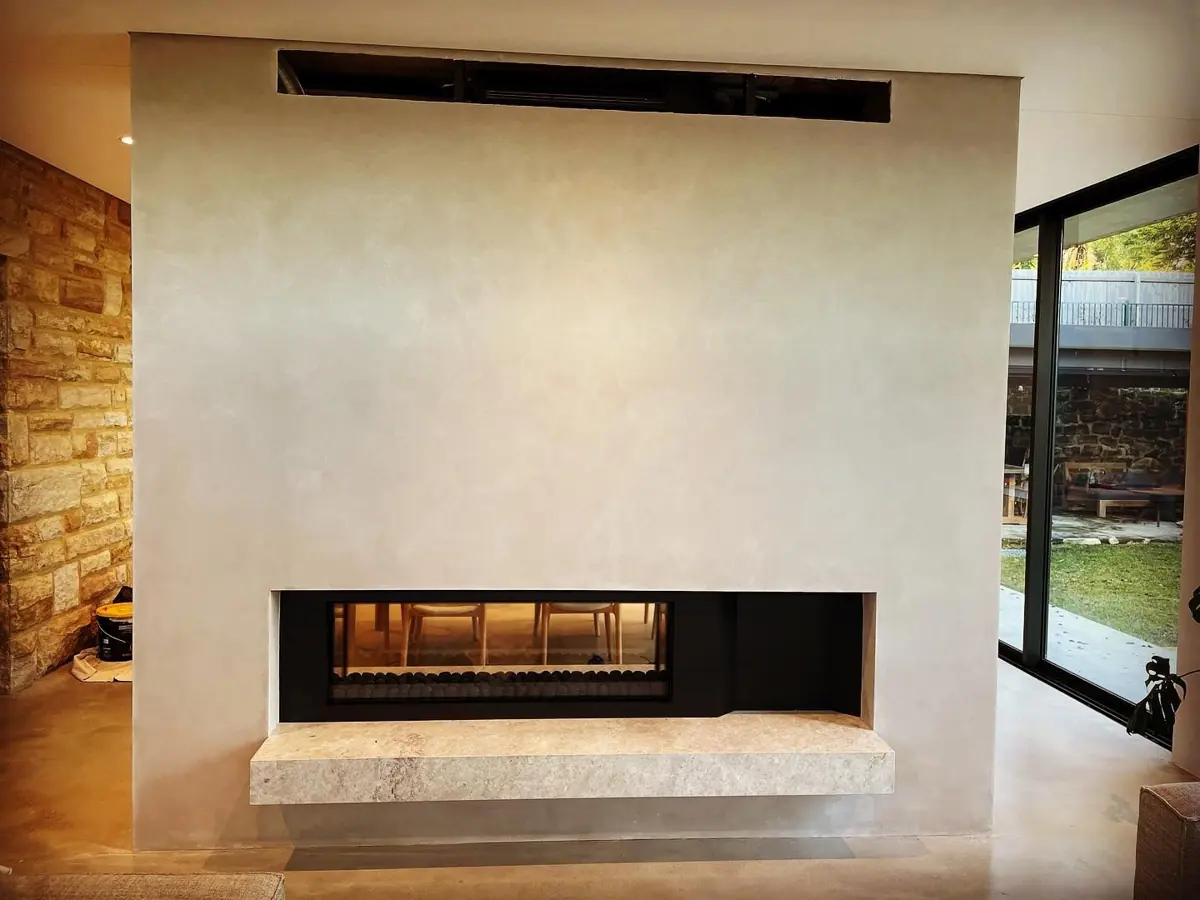 Decorative plaster finish on a feature fireplace wall